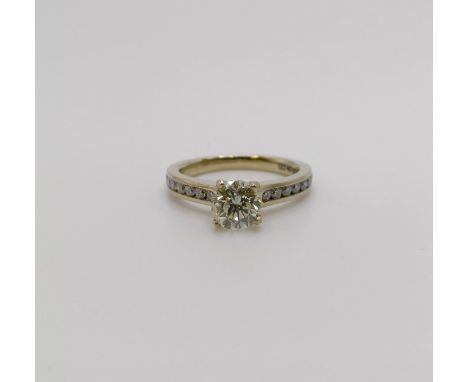 An 18ct gold and diamond solitaire ring, approx. 1.1ct, with diamond set shoulders, ring size I 