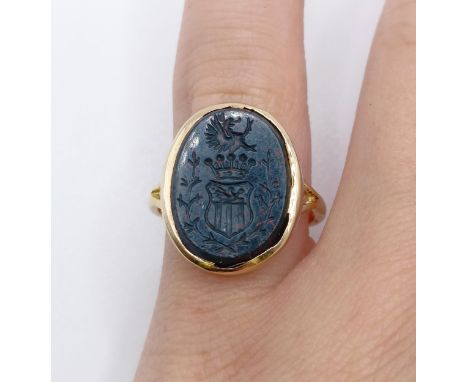 An 18ct gold, diamond and bloodstone intaglio ring, carved a crest, ring size F3.7g all instone 16mm x 11 mmsome scratchesthe