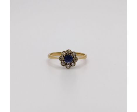 An 18ct gold, diamond and sapphire flowerhead ring, ring size J 