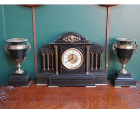 DECORATIVE BLACK SLATE MANTEL CLOCK WITH BRASS COLUMNS, ORMOLU MOUNTS AND ENAMELLED DIAL.  ALSO PAIR OF GARNITURES TO ACCORD.
