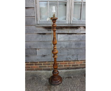 A walnut turned standard lamp, on circular base, 54" high 