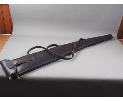 A dark brown leather rifle slip with sheepskin interior, 53" long 