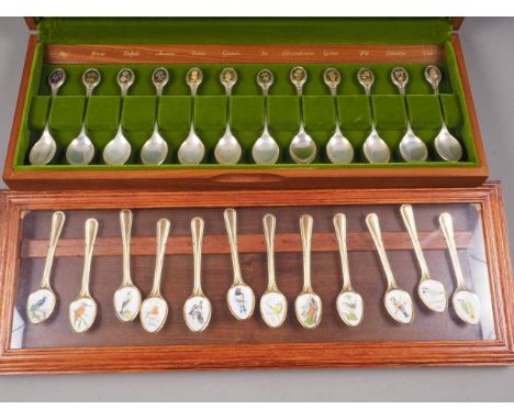 A set of twelve silver Royal Horticultural Society flower spoons, in mahogany case, 10oz troy approx, and twelve gilt and ena