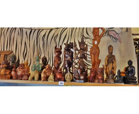 Shelf of assorted Oriental carved wood and metal buddhas and other figures (21 items)