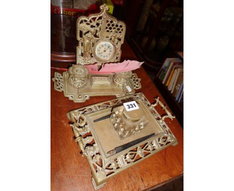 Pierced brass inkstand with glass inkwell and another two inkwells and ornate clock to back