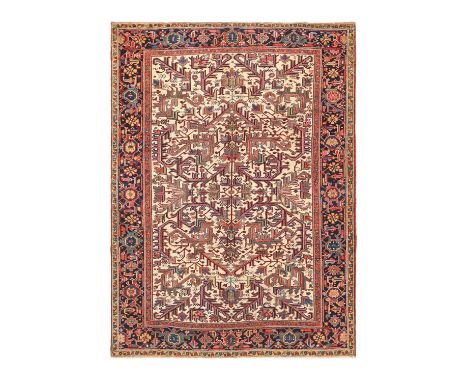 Heriz Carpet of Unusual SizeNorthwest Iran, Circa 1920The ivory field with an allover design of stylised angular plants, fram