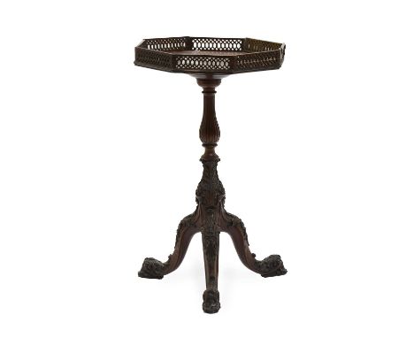 A George II-Style Carved Mahogany Tripod Table, 19th Century, the octagonal top with fret cut gallery and pull-out candle sli