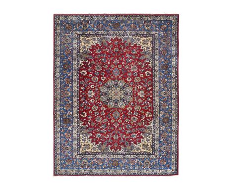 Isfahan CarpetCentral Iran, Circa 1970The raspberry field of birds and scrolling vines centred by an indigo pole medallion fr