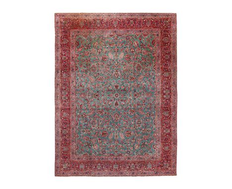Unusual Kashan CarpetCentral Iran, Circa 1935The green/blue field of meandering vines and palmettes framed by borders of scro
