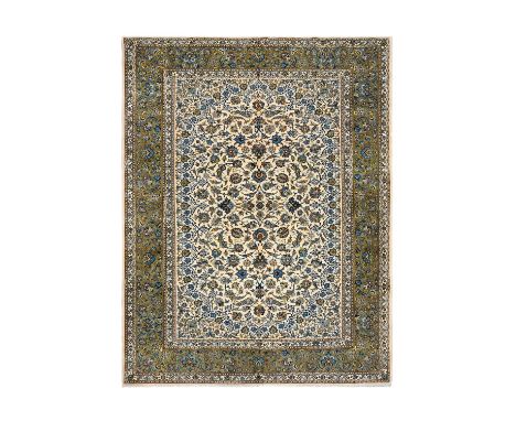 Kashan CarpetCentral Iran, Circa 1970The ivory field with an allover design of palmettes and scrolling vines framed by border
