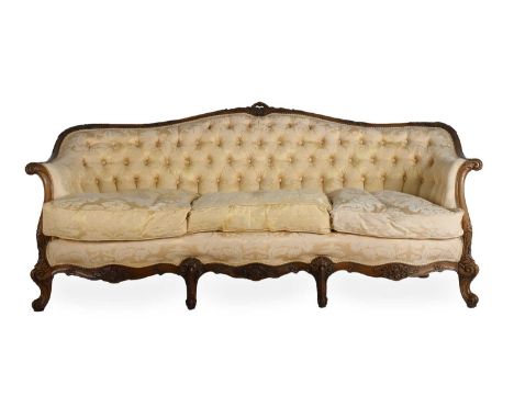 A French Style Walnut Framed Three-Seater Sofa, late 19th century, upholstered in yellow floral damask, the moulded and carve