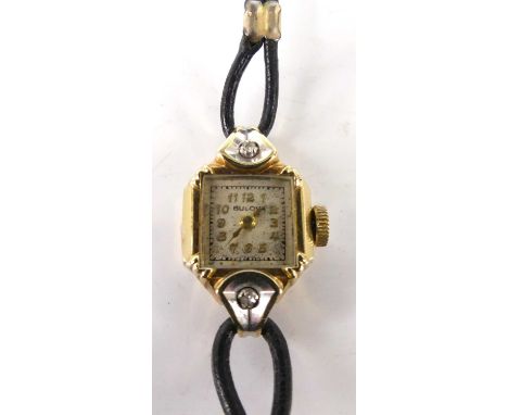 A lady's Bulova 14ct gold cased dress watch, the lugs each set with a small round cut diamond, the watch having signed silver