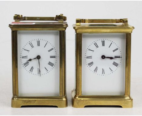 An early 20th century lacquered brass carriage clock, probably French, having an unsigned white enamel dial, h.12cm; together