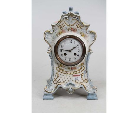 A Victorian Rococo style pottery mantel clock, the enamel dial showing Arabic numerals, having an 8 day movement, height 35cm