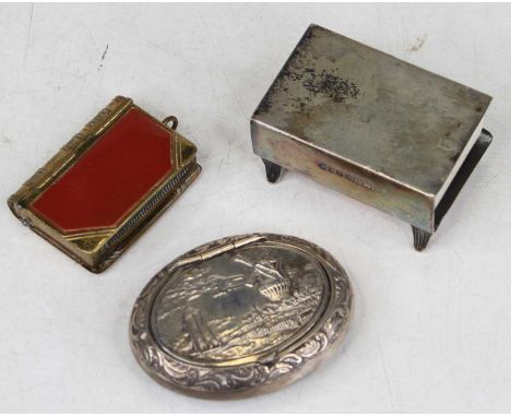 A reproduction Dutch white metal snuff box of compressed oval form, the lid repoussee decorated with a windmill beside a rive