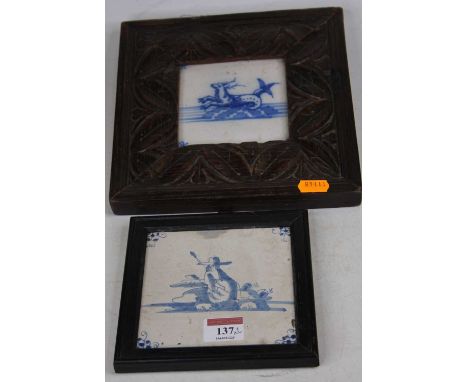 An 18th century Delft tile, decorated with a figure within spiderhead corners, 12x12cm, together with anotherThe tiles are ap