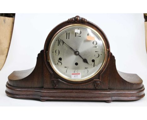 A circa 1920 German "Napoleons hat", oak cased mantel clock, having a silvered Arabic dial with three winding holes for a thr