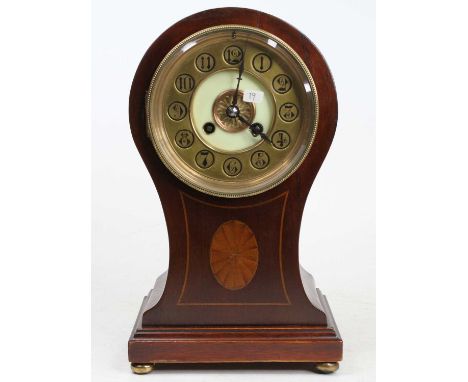 An Edwardian mahogany and inlaid balloon shaped mantel clock, having a brass chapter ring, twin winding holes for a French br