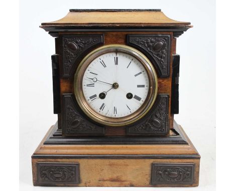 A late Victorian walnut and ebonised mantel clock, having a white enamel Roman dial (hairline) and French brass eight-day cyl