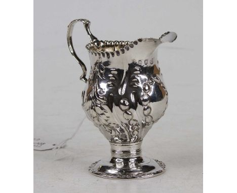 A George II silver and embossed pedestal cream jug, of helmet form, 2.8oz, London 1759, h.9.5cm 