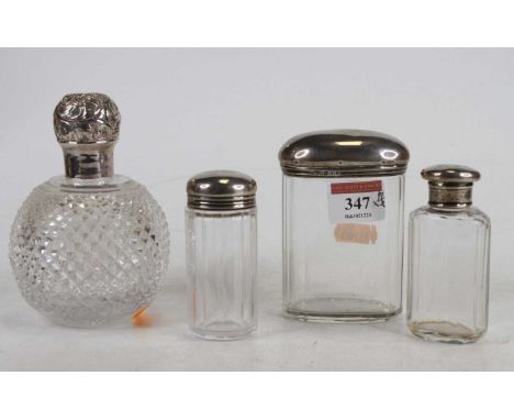 A late Victorian cut glass and silver topped scent bottle, h.12cm; together with three various thumb-cut glass and silver top