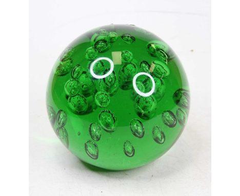 A large green glass paperweight, having bubble decoration, height 14cm