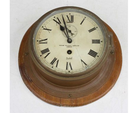 An early 20th century brass cased ship's bulkhead clock, the painted dial with Roman numerals and signed Marine Nautical Supp