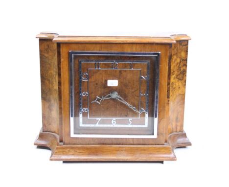 An Art Deco walnut and burr walnut cased mantel clock, having a silvered square Arabic chapter ring, and key wind Buren movem