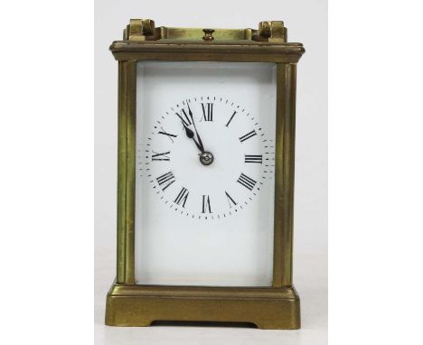 A 20th century lacquered brass cased carriage clock, having visible platform escapement, with white enamel dial with Roman nu
