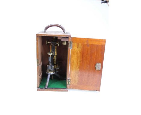A 19th century brass monocular microscope, the stage above a tripod base, inscribed W Watson &amp; Sons, 313 High Holborn, Lo