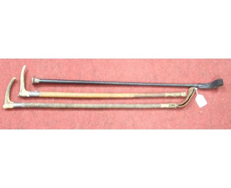 A mid 20th century leather riding crop having a silver clad handle, length 73cm together with two antler handled riding crops