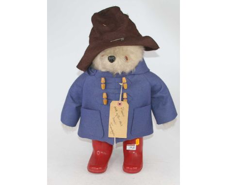 A vintage Paddington Bear wearing a hat, blue duffel coat, and red wellies, height 50cmIn good condition with minimal signs o