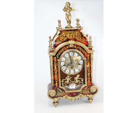 A French style brass and boulle type mantel clock, the dial showing Roman numeral enamel cartouches, height 57cm