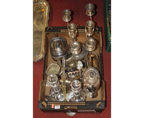 A box of assorted silver plated wares, to include pair of three-light candelabra, pair of single candlesticks, three-piece te