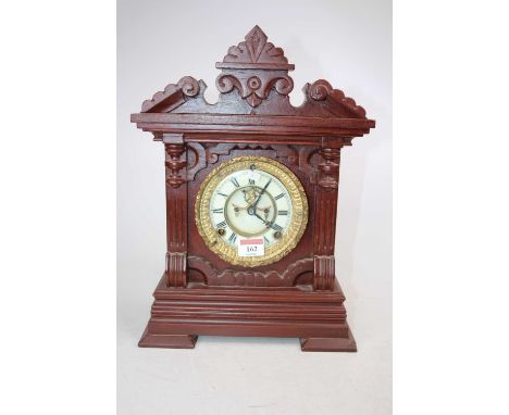 An early 20th century Ansonia mantel clock, the enamel chapter ring showing Roman numerals, having visible anchor escapement,