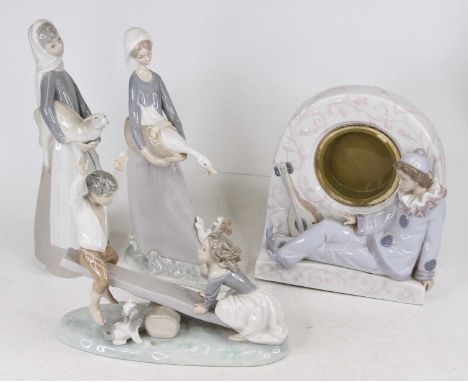 A Lladro porcelain figure of a boy and girl on a see-saw shown on naturalistic base, height 20cm, together with two other Lla
