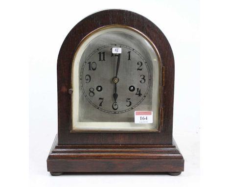 An Edwardian oak cased dome topped mantel clock having an  unsigned silvered Arabic dial, the eight-day brass movement striki