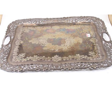 A late Victorian silver plated twin handled tray, having a raised pierced border and engraved ground (tarnished), w.63cm 