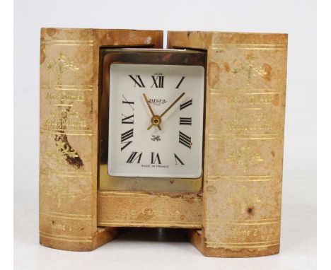A Jaeger mystery travel clock disguised behind two gilt tooled leather books, mid-20th century, h.10.5cm 