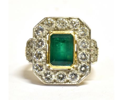 AN 18CT GOLD DIAMOND AND EMERALD COCKTAIL RING  the octagonal plaque measuring 1.9cm by 1.6cm and comprising a step cut emera