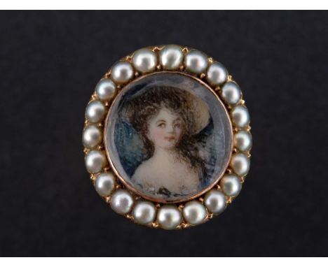 A GEORGIAN PORTRAIT MINIATURE RING The glass fronted miniature featuring a portrait of a young female, set in a mount of seed