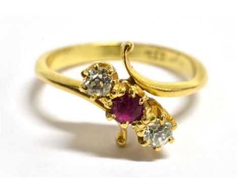 AN 18CT GOLD, DIAMOND AND RUBY CROSSOVER RING  With faded 18ct stamp to the shank, ring size L ½, weight 3.4g.