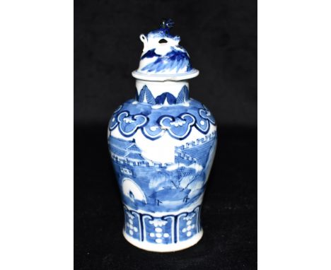 A SMALL CHINESE BALUSTER SHAPED VASE AND COVER  underglaze blue painted decoration of a figure standing before a palace withi