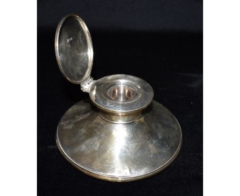 A LARGE WEIGHTED SILVER INKWELL  the inkwell of plain form and hallmarked for London 1925, base diameter 15cm, height 7cm Con