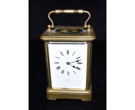 A BRASS CASED CARRIAGE CLOCK   the enamel dial signed 'DENT ROYAL EXCHANGE CORNHILL LONDON',  the French 8-day movement strik