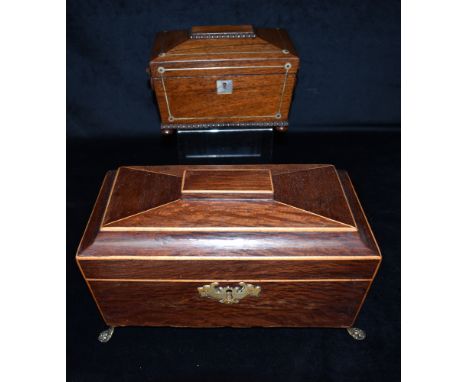 A BRASS MOUNTED VICTORIAN ROSEWOOD TEA CADDY  of sarcophagus form, the fitted interior with twin compartments and mixing bowl