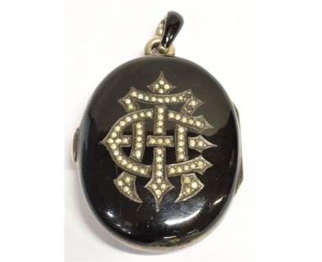 A LARGE MID VICTORIAN SEED PEARL AND ENAMEL MEMORIAL LOCKET  the black enamelled locket with seed pearl decoration to one sid