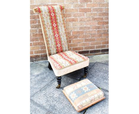 A VICTORIAN PRIE DIEU CHAIR  with woolwork tapestry upholstery, on turned and ebonised supports with brass casters, toghether