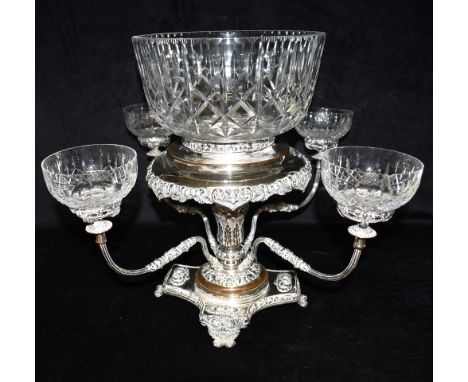 A SILVER PLATED EPERGNE Ornately decorated with copper detail, the central column with four scroll supports, raised on a squa