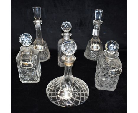 SIX DECANTERS AND STOPPERS  each with hallmarked silver wine labels for Sherry, Gin, Whiskey, Brandy, Madeira and Port, the t